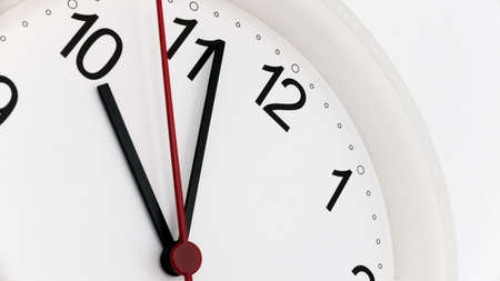 Closeup white clock ticking showing ten hours. Time concept.