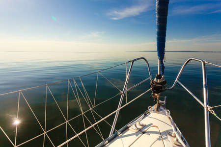 Lapper genoa roller jib, jibsheet on boat during cruise on sea water, sunny day.