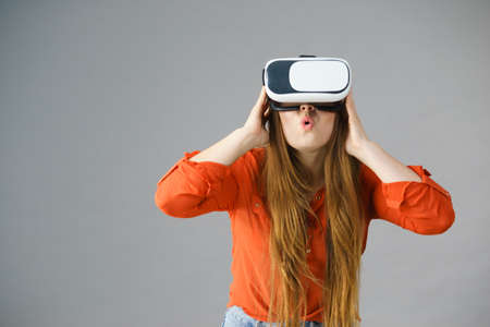 Young emotional woman wearing virtual reality goggles headset, vr box. Connection, technology, new...