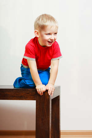 Childhood, kids imagination concept. Little young boy playing on table and having funの写真素材