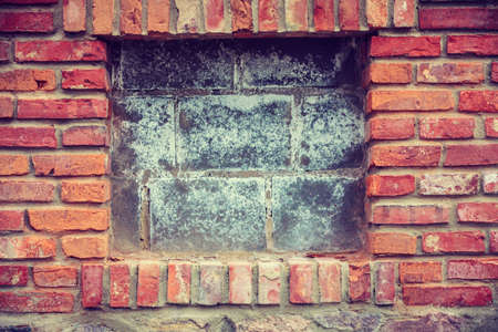 Textures and close up detailed patterns concept. Red brick wall with wooden pieces