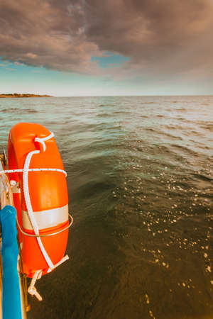 Water traveling, adventure concept. Sea view from yacht, lifebuoy close up, calm water, sunny...