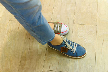 Unrecognizable woman trying on new shoes, getting comfortable in shop buying and choosing best...