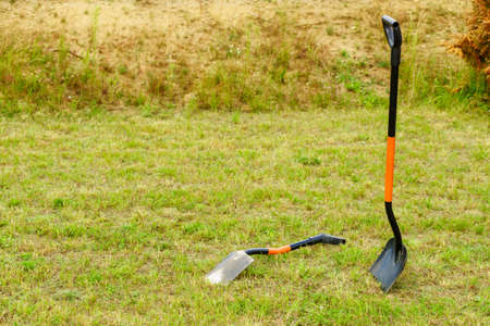Shovel spade work tools standing outside. Gardening and agricultural equipment essentials concept.の写真素材