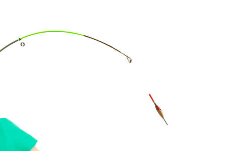 Spinning sport equipment concept. Person holding fishing rod with float and waggler with line.の写真素材