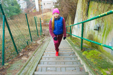 Outdoor sport exercises, sporty outfit ideas. Woman wearing warm sportswear training exercising outside during autumn.の写真素材