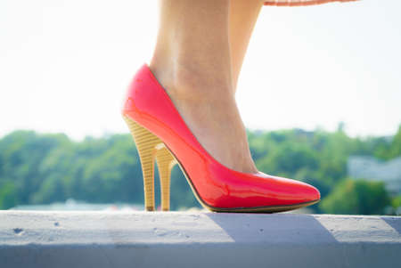 Fashion and footwear. Red high heel classic shoes outdoor during sunny day.の写真素材