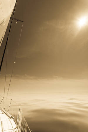 Yachting on sail boat during sunny summer weather on calm sea water. Sporty transportation concept.