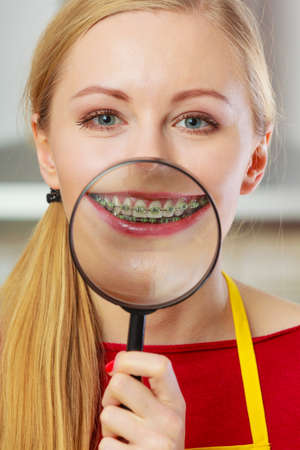 Dentistry and stomatology concept. Happy smiling woman showing her braces on teeth through...