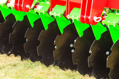 Agriculture equipment concept. Detailed closeup of disc harrow, agricultural machinery. Outdoor shot