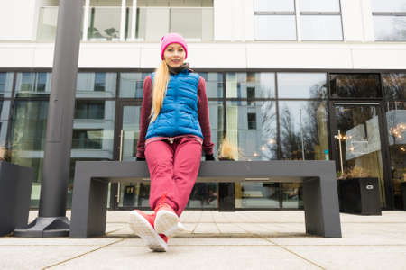 Outdoor sport exercises, sporty outfit ideas. Woman wearing warm sportswear training exercising, stretching herself outside during autumn.の写真素材