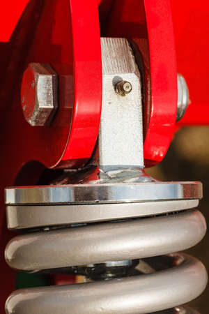 Auto, transport vehicles concept. Detailed closeup of shock absorber, big snubber made of steel and...