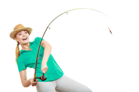 Fishery, spinning equipment, angling sport and activity concept. Happy smiling woman with fishing rod.の写真素材