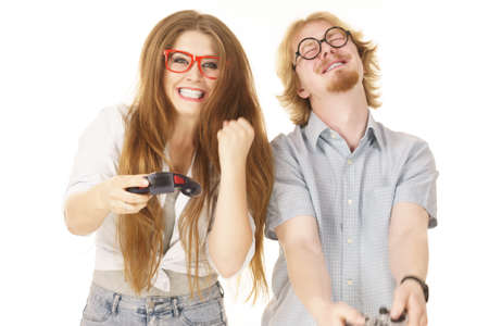 Happy couple enjoying leisure time by playing video games together. Studio shot isolated