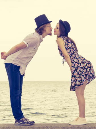 Vintage funny retro couple, man and woman enjoying their romantic date outside wearing fedora hats.の写真素材