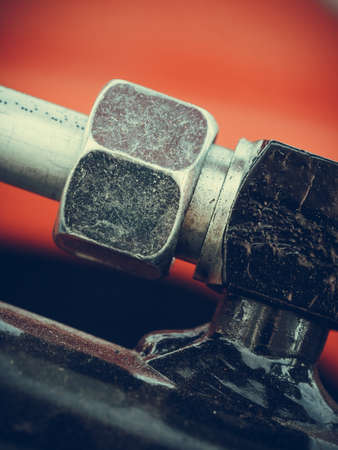 Industrial detailed pneumatic, hydraulic machinery concept. Pump made of steel on red machine...