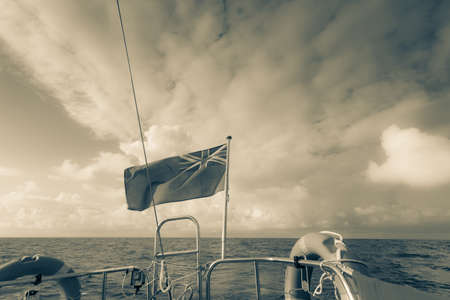 Civil banner United Kingdom flag on sailing boat yacht in front bow.