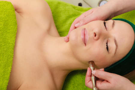 Beautician doing diamond microdermabrasion on woman. Beauty, relaxation, skincare, cosmetology modern devices, wellness in spa concept.の写真素材