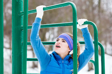 Outdoor sport exercises, sporty outfit ideas. Woman wearing warm sportswear urban street training...