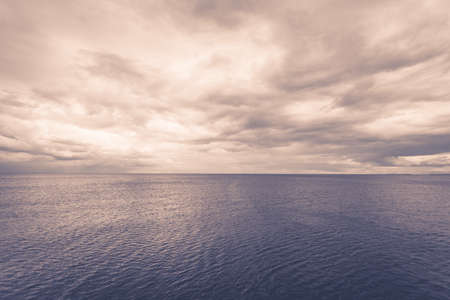 Minimalist idyllic shot of horizontal sea water and sky during cloudy day. Beauty of nature concept.の写真素材