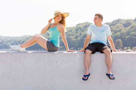 Relationship goals, outdoor relaxation, love and friendship concept. Man and woman sitting together outside hugging, having date.の写真素材