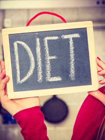 Dieting and detoxing, weight loss concept. Woman holding board with detox signの写真素材