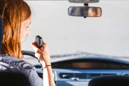 Talking while drive, auto walkie talkie, comunication concept. Young man driving car using cb radio
