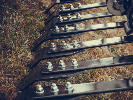 Agriculture industrial equipment concept. Closeup of ripper machinery rods with many screwsの写真素材