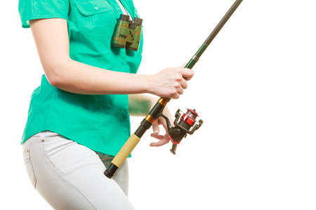Fishery, spinning equipment, angling sport and activity concept. Woman with fishing rod.の写真素材