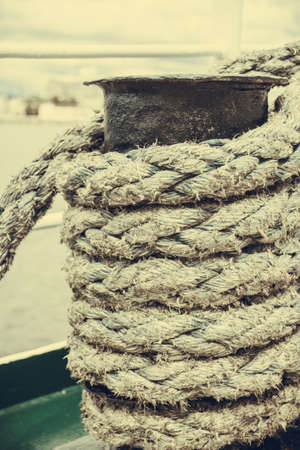 Jetty objects concept. Harbor marina bolt with ship and boats ropes, outdoor shotの写真素材