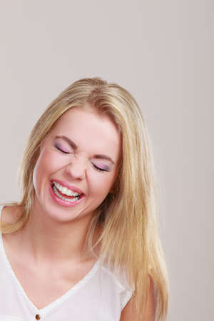 Happiness positive emotion. Healthy smiling girl portrait on grayの写真素材