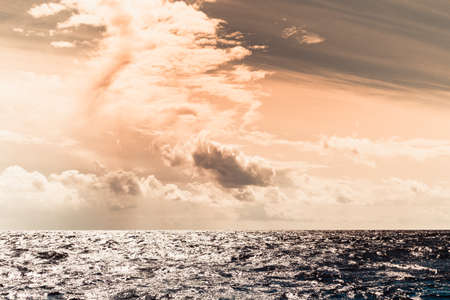 Colorful sunset over evening sea horizon, clouds sky. Tranquil scene. Natural background. Landscape. View from yachtの写真素材