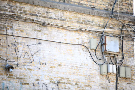 Electric controller box and tangle of cables wires  on the brick wallの写真素材
