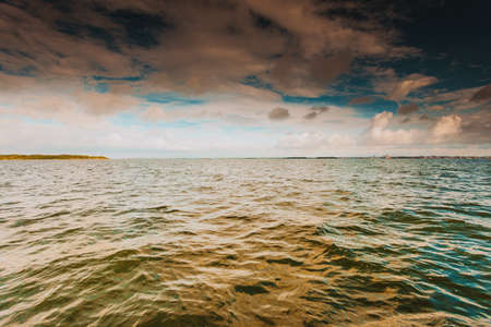 Colorful sunset over evening sea horizon, clouds sky. Tranquil scene. Natural background. Landscape. View from yachtの写真素材