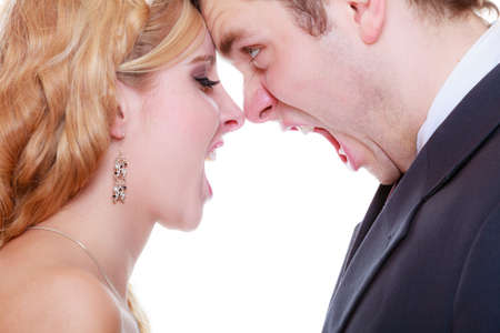 Relationship problems and troubles concept. Groom and bride having quarrel argument, yelling at each...