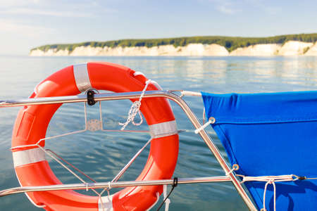 Detailed close up of rescue ring on sailing boat handrail during cruise on water, Sassnitz cliff in...