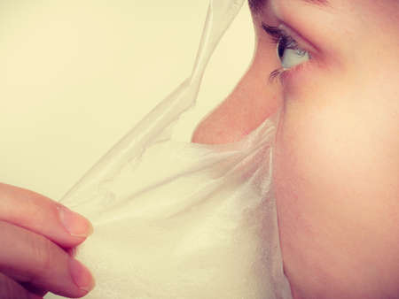 Beauty skin care cosmetics and health concept. Young woman face profile, girl removing facial peel off mask. Peeling.の写真素材