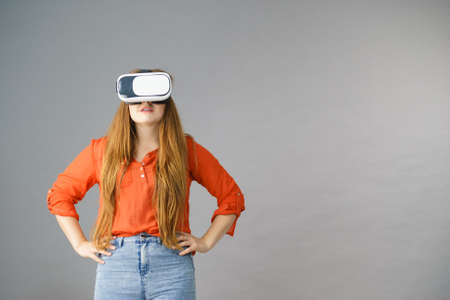 Smiling positive woman wearing virtual reality goggles headset, vr box. Connection, technology, new...