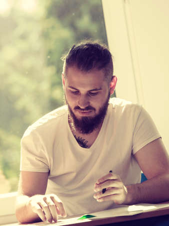 Man student sitting in class studying and educating waiting for teacher. Creating new ideas by young peopleの写真素材