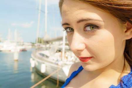 Beauty of feminity concept. Closeup portrait of beautiful brunette woman, outside shoot in marina.の写真素材