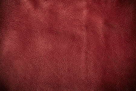 Red leather texture closeup grunge background. Country western background, cowboy rawhide design, abstract patternの写真素材