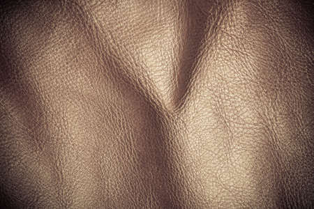 Brown leather texture background closeup. Folds wavy natural skin materialの写真素材