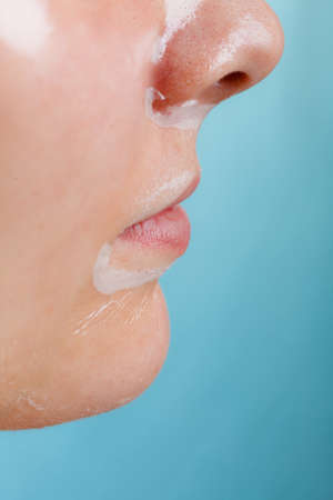 Close up young woman in facial peel off mask, part of face. Peeling. Wellness and skincare.の写真素材