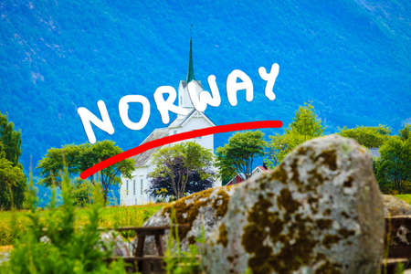 Mountain landscape and the white wooden Oppstryn Church in Stryn Municipality in Sogn og Fjordane county, Norway.の写真素材