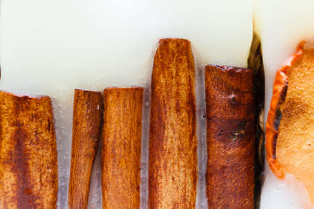 Background ideas, home decorative decorations concept. Detailed closeup of cinnamon in candle waxの写真素材