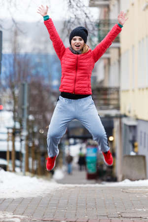 Woman jumping outdoor. Winter sport concept.の写真素材