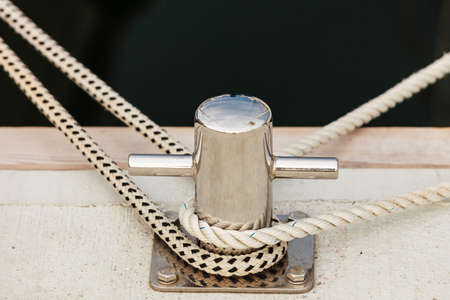 Jetty objects concept. New metal steel harbor marina bolts with ship and boats ropes.の写真素材