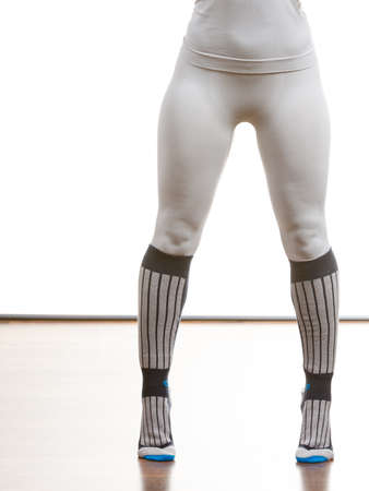 Clothing fashion sport concept. Fit female legs wearing thermoactive underwear pants trousers. Slim...