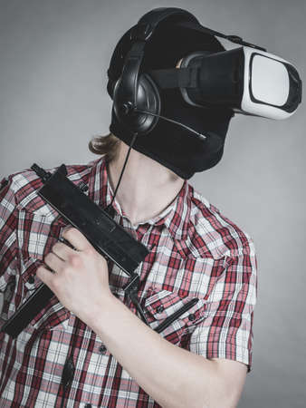Man playing video game wearing virtual reality device. Gaming equipment for gamers concept.