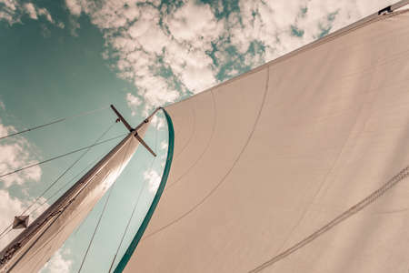 Detailed closeup of sail fabric on sailboat, outdoor shot. Marine objects concept.